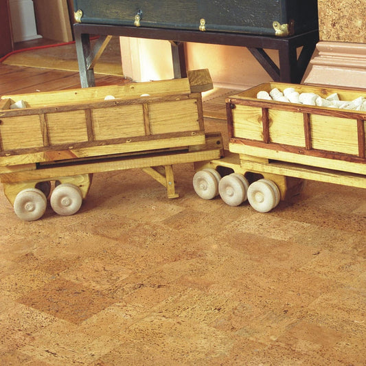 Jelinek Harmony floating cork flooring installed in a bright family room, with a small wooden toy truck resting on the warm cork floor
