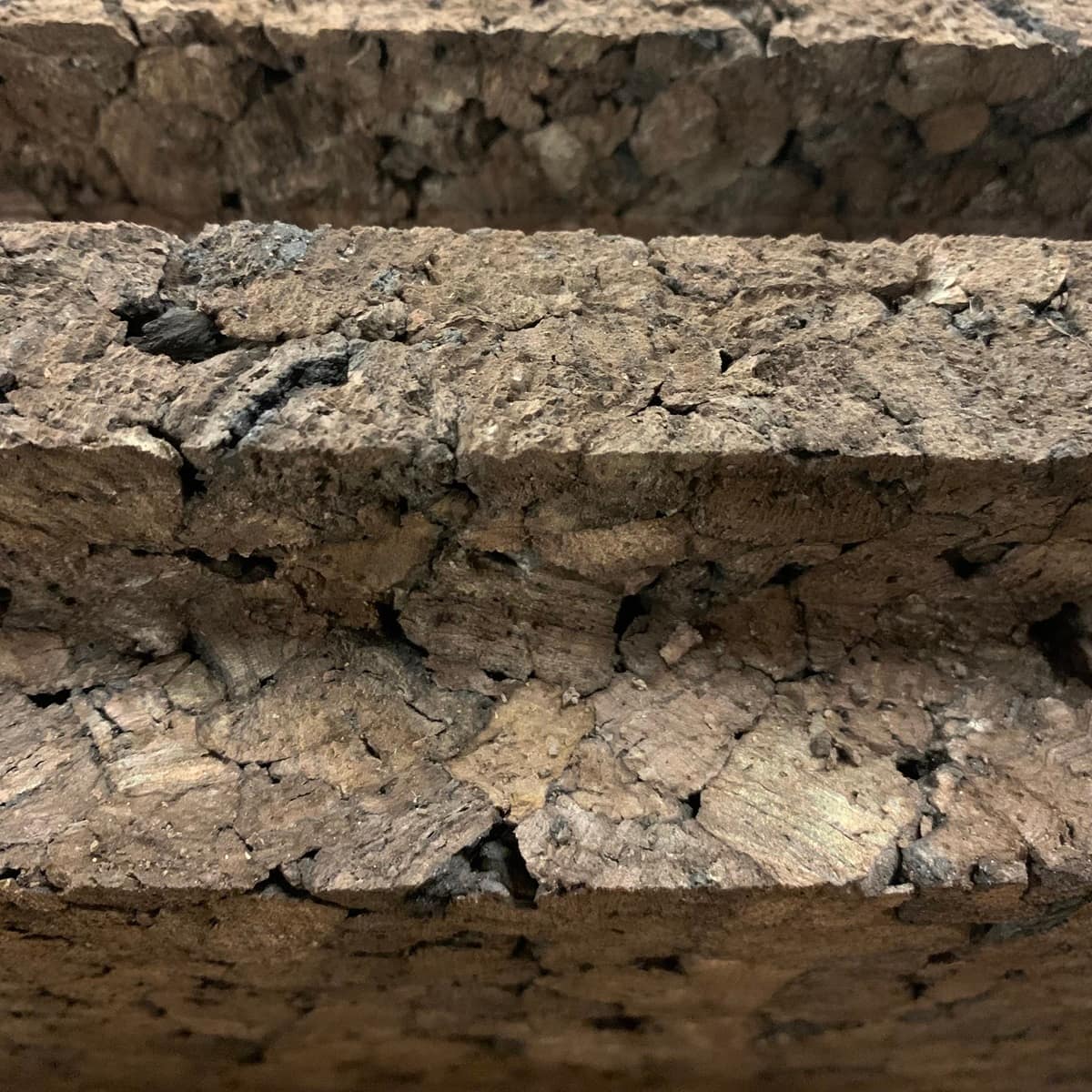 Closeup of dark insulation cork showing the shiplap edges of the 2 inch cork board