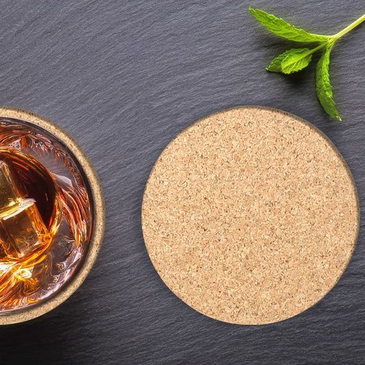 Two round cork coasters—one showing top and side, one holding a glass of liquid.