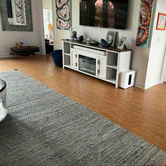 Casablanca cork flooring installed in a living room with a throw rug over a section of it.