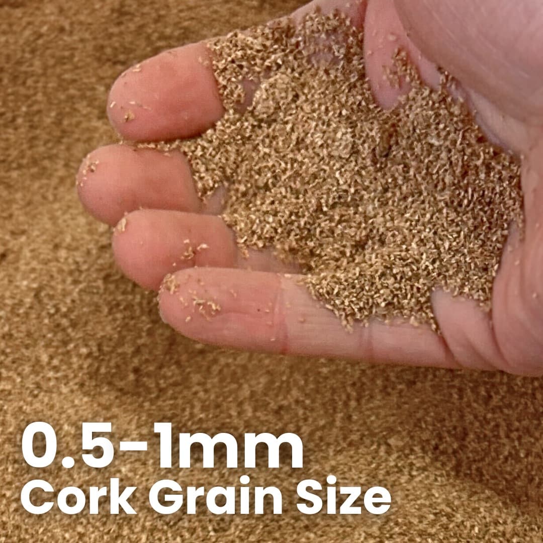 Hand holding granulated cork grain to show the texture, grain size and color.