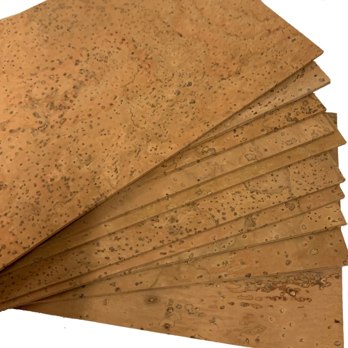 Top quality, all natural solid cork sheets for musical instruments fanned out to show the quality.