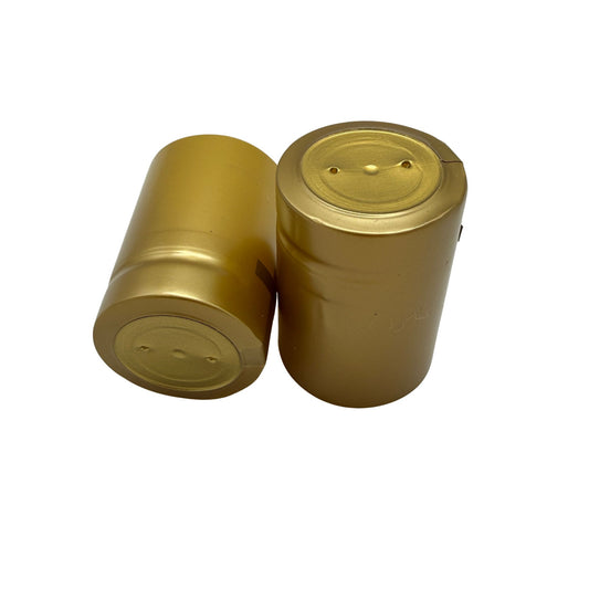 Close-up of shrink caps that are matte gold with closed cap