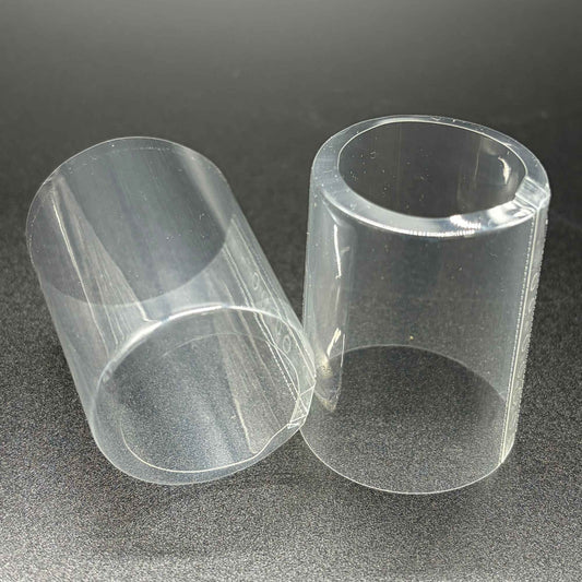 Two open cap PVC shrink caps with vertical perforation, close-up view.