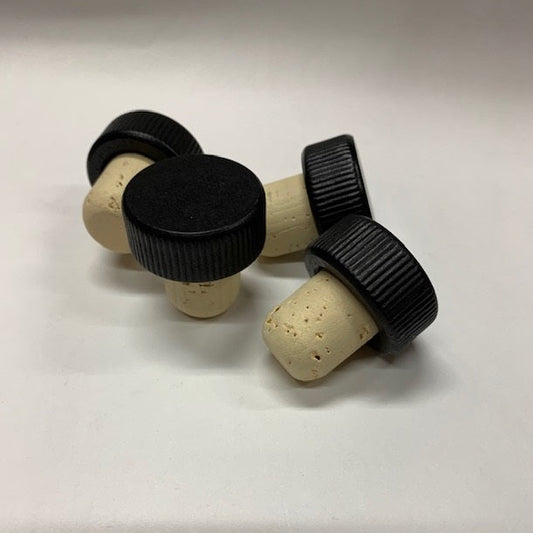 A pile of black wood top stopper with ribbed edges and a natural cork stem with rounded end. 