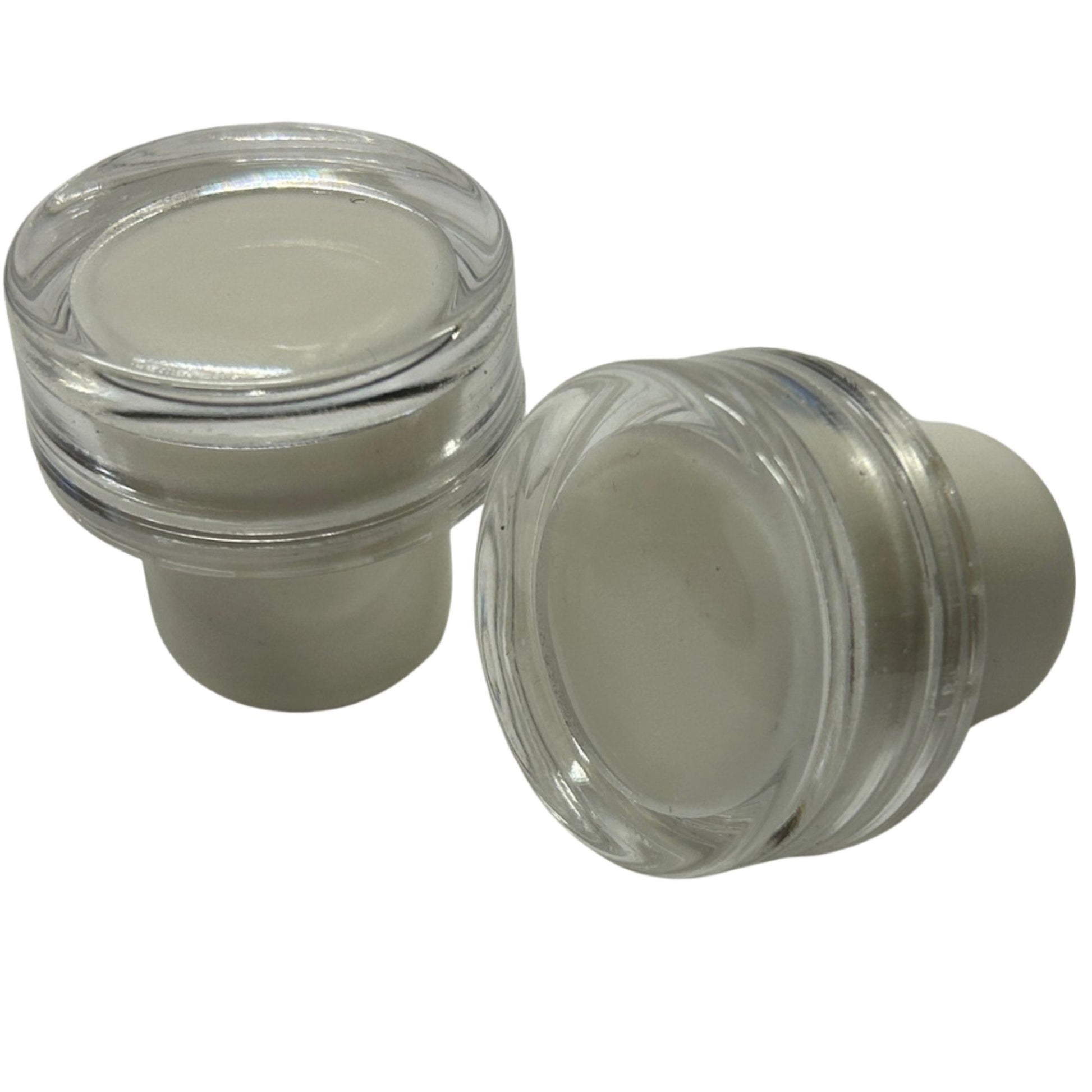 Two clear acrylic bottle stoppers with a clear acrylic top and a white synthetic cork stem