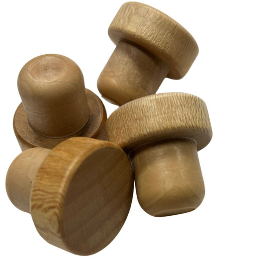Close-up view of several natural wood top stoppers with synthetic cork stems