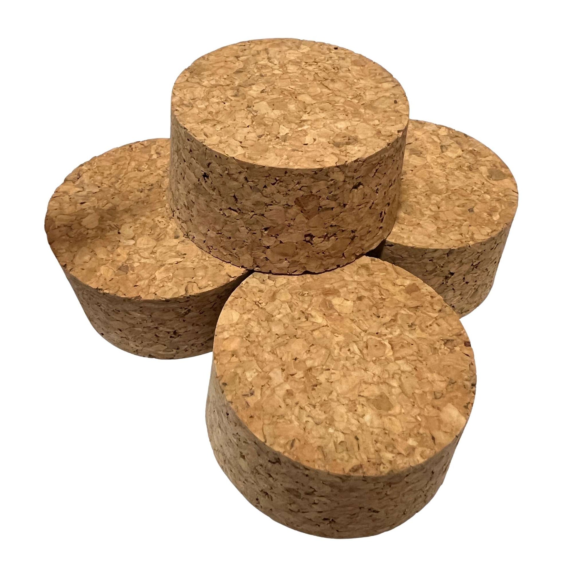A stack of agglomerate short length tapered cork stoppers, size SL28