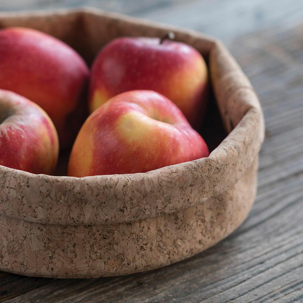 Cork Adjust-A-Bowl with folded edges holding apples. 
