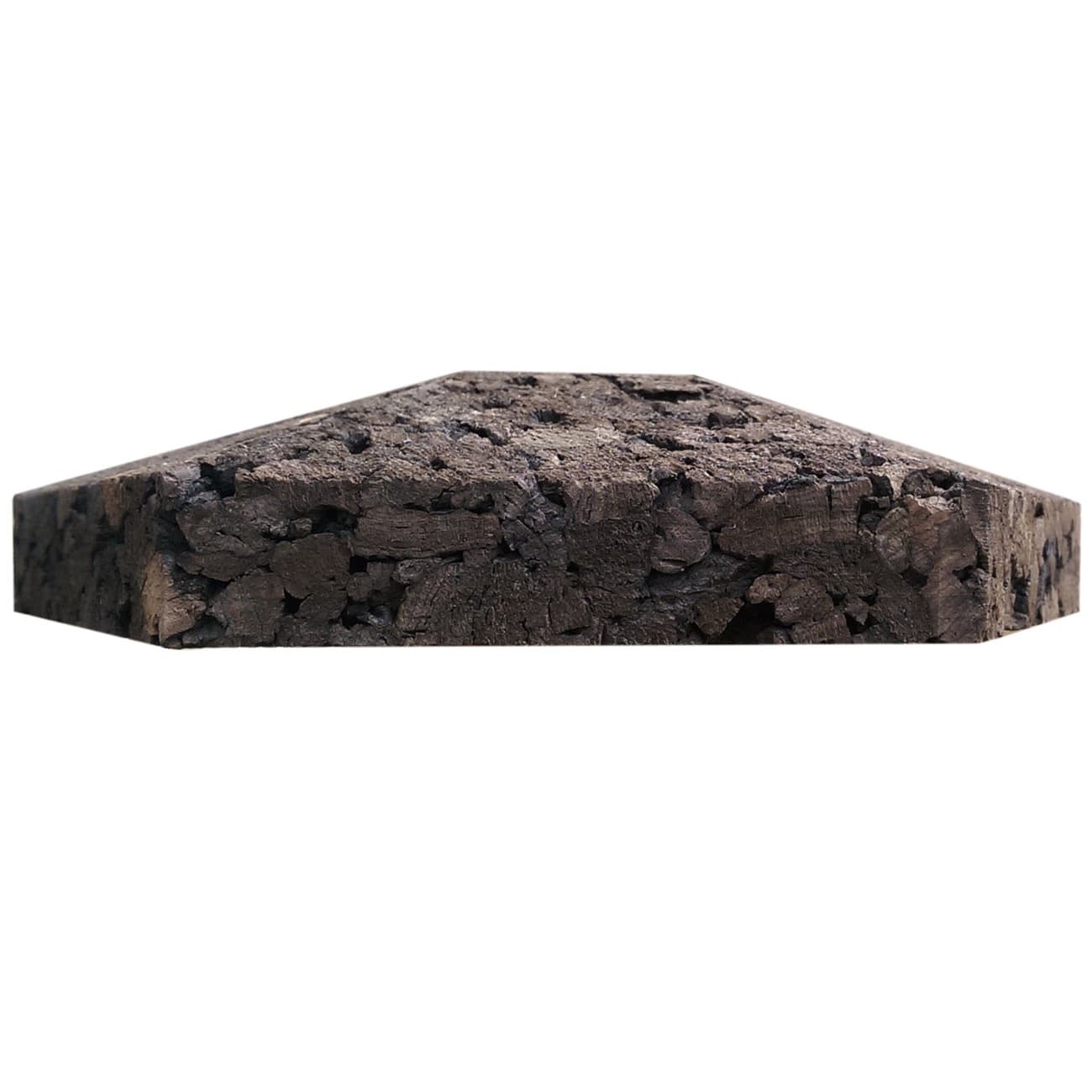 Hexagonal cork wall tile with a rough texture on a white background