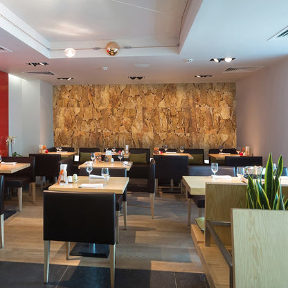 Modern restaurant interior with tables, chairs, and a Arizona Cork wall.