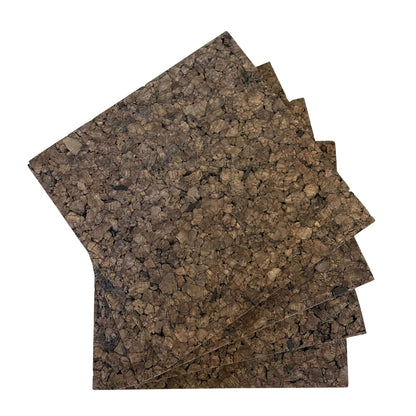 Four dark cork insulation tiles fanned out to show quantity, natural texture, and deep brown color