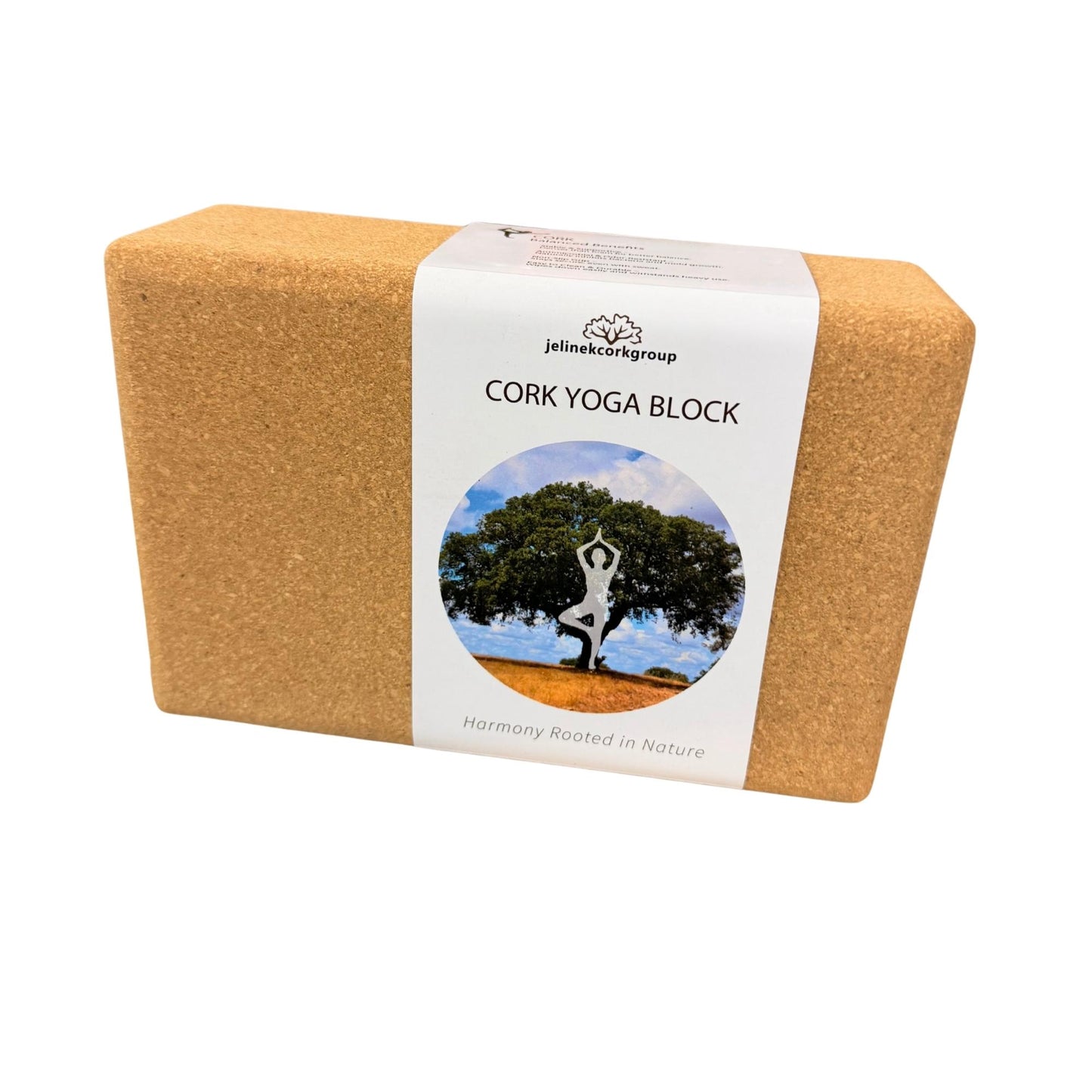 A rectangular cork yoga block with a white paper label wrapped around it, photographed on a plain white background. The label reads 'Jelinek Cork Group CORK YOGA BLOCK' and features a circular photo of a tree and a yoga pose.